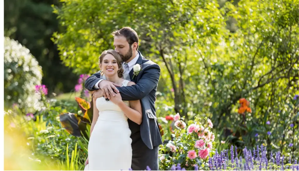 A couple embracing among garden flowers