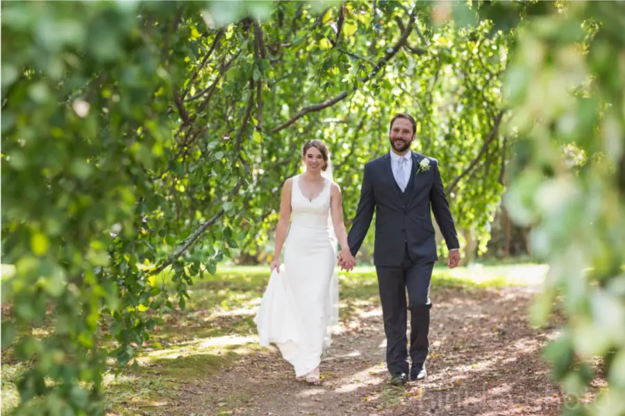 A couple walking a shaded garden path