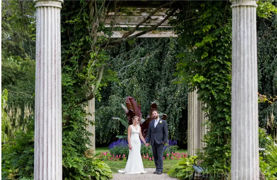 A couple beneath the columns of the pergola