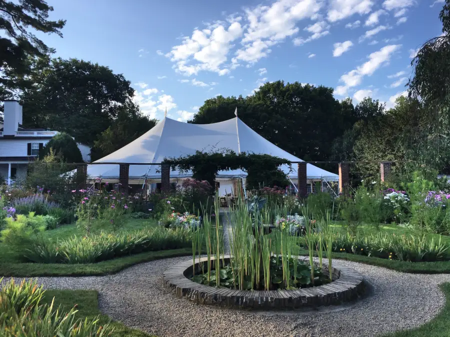 The sailcloth tent beyond the fountain garden